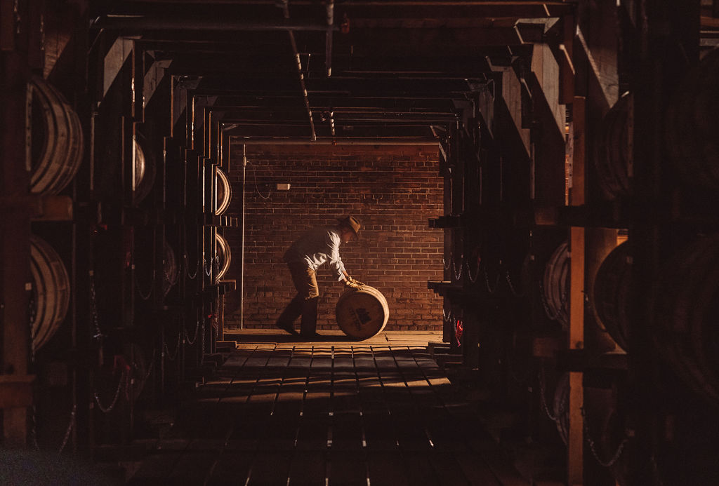 Rolling a bourbon barrel at the distillery